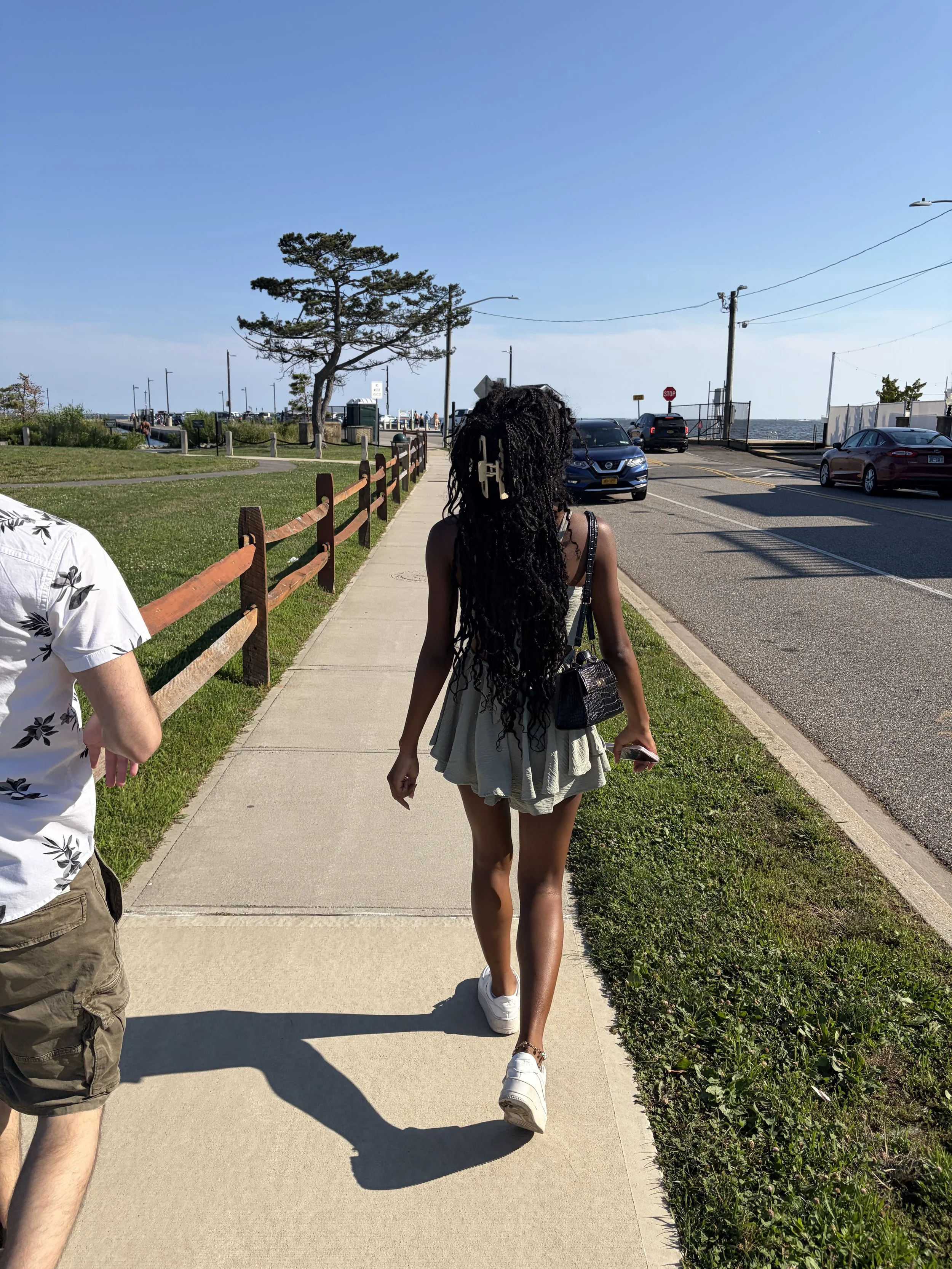 green-romper-walking-on-sidewalk