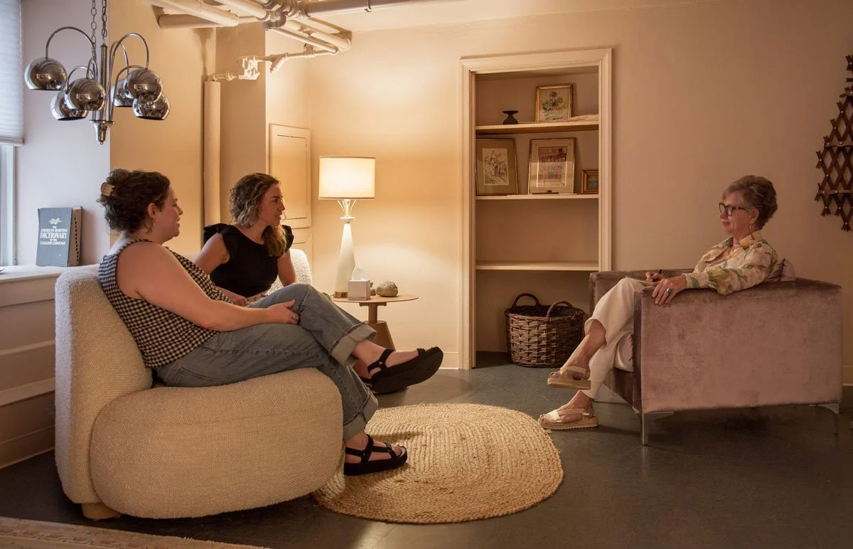 Three women having a conversation in a cozy therapy room in East Falls, Philadelphia.