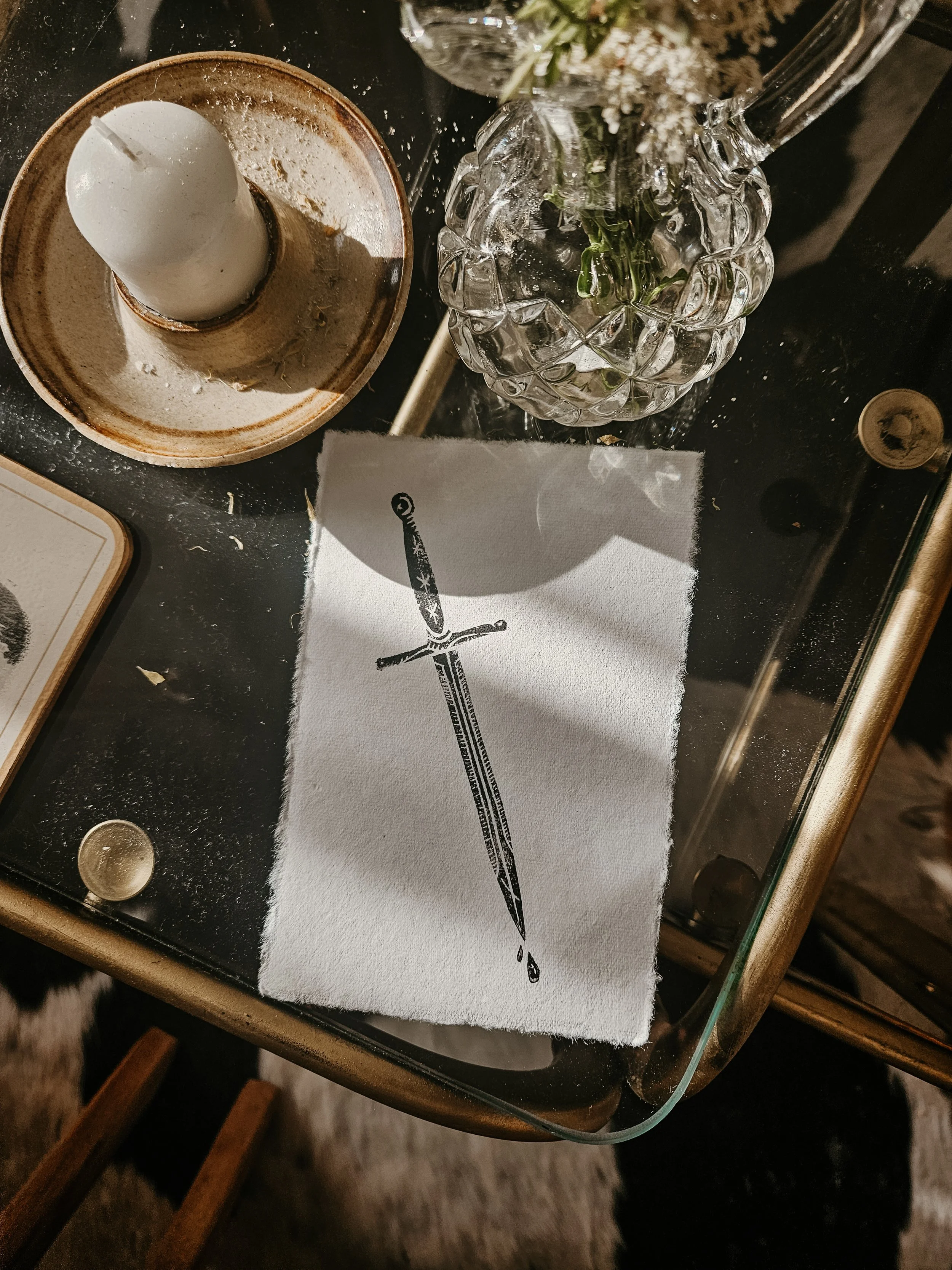 Linocut print of a sword on a coffee table