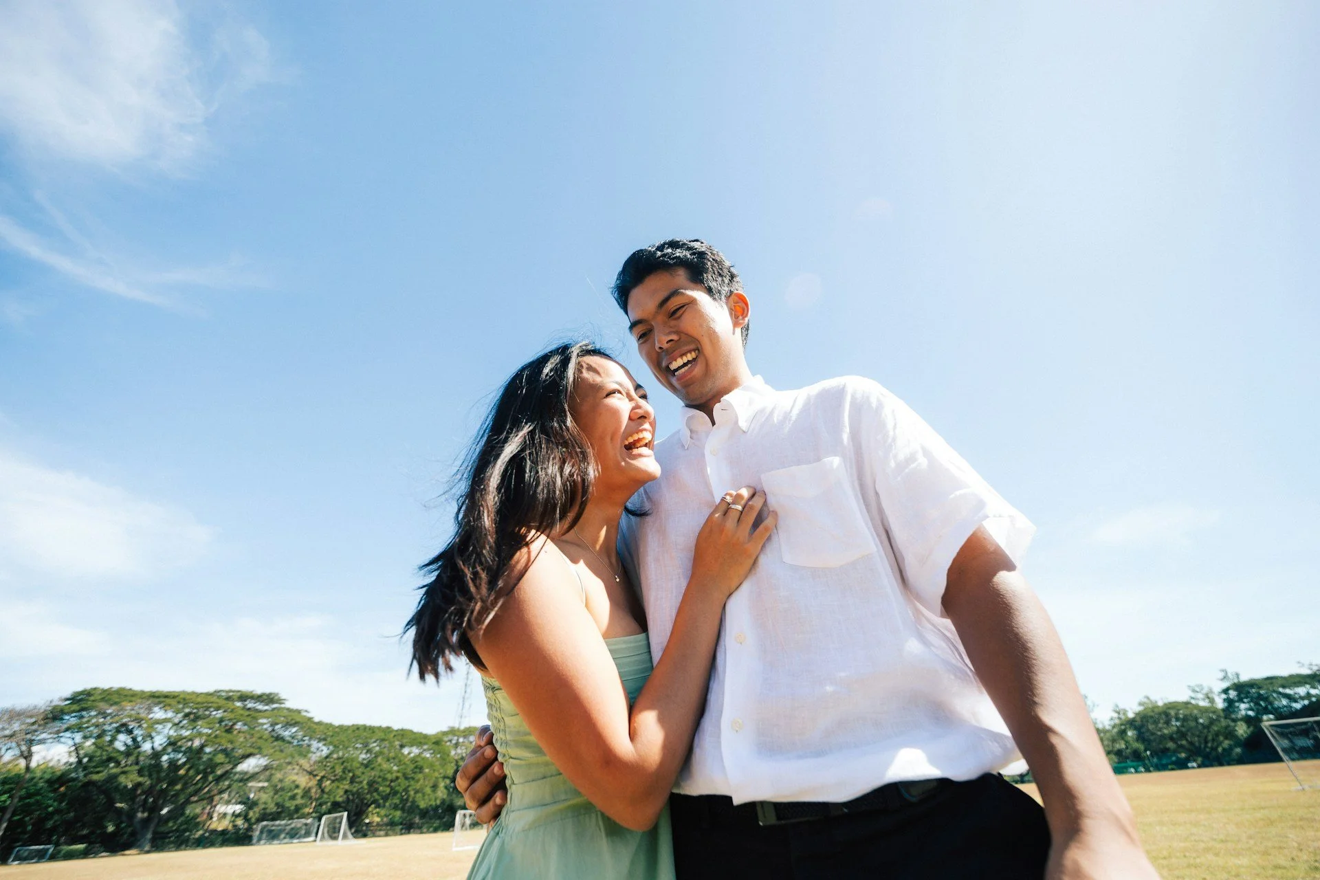 Smiling couple embracing outdoors, symbolizing emotional connection and relationship healing after childbirth