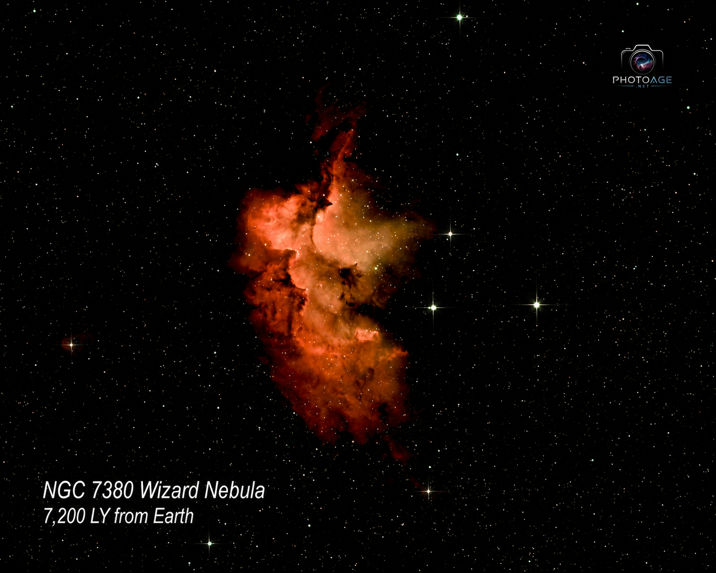 A colorful nebula with red, orange, and yellow hues, surrounded by stars in space. Text indicates it is the NGC 7380 Wizard Nebula, located 7,200 light-years from Earth.