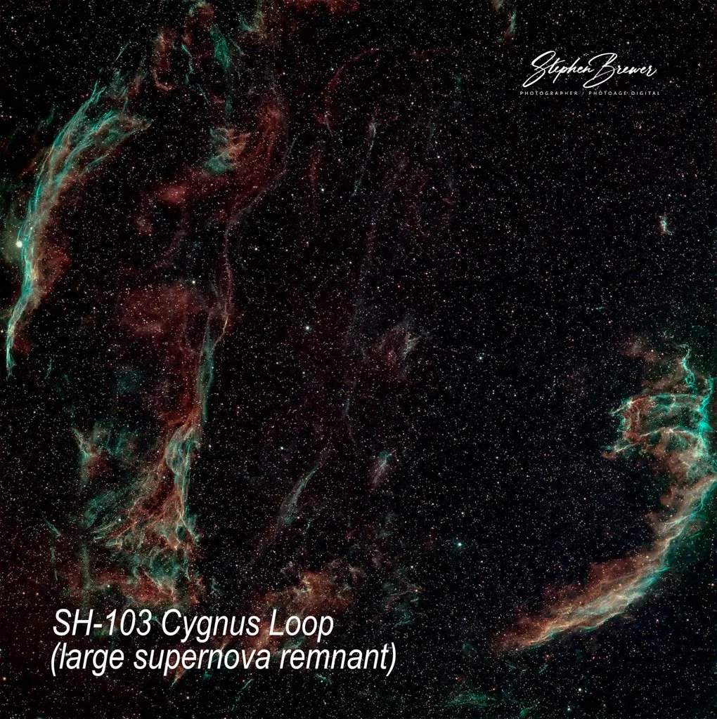 Image of outer space showing a nebula and numerous stars. Text on the image reads 'SH-103 Cygnus Loop (large supernova remnant)' and includes the signature of photographer Stephen Brewer.