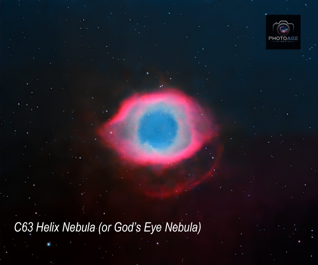 Image of the C63 Helix Nebula, also known as God's Eye Nebula, showing a colorful planetary nebula with a central hollow blue area surrounded by red and pink gaseous clouds, set against a starry background.