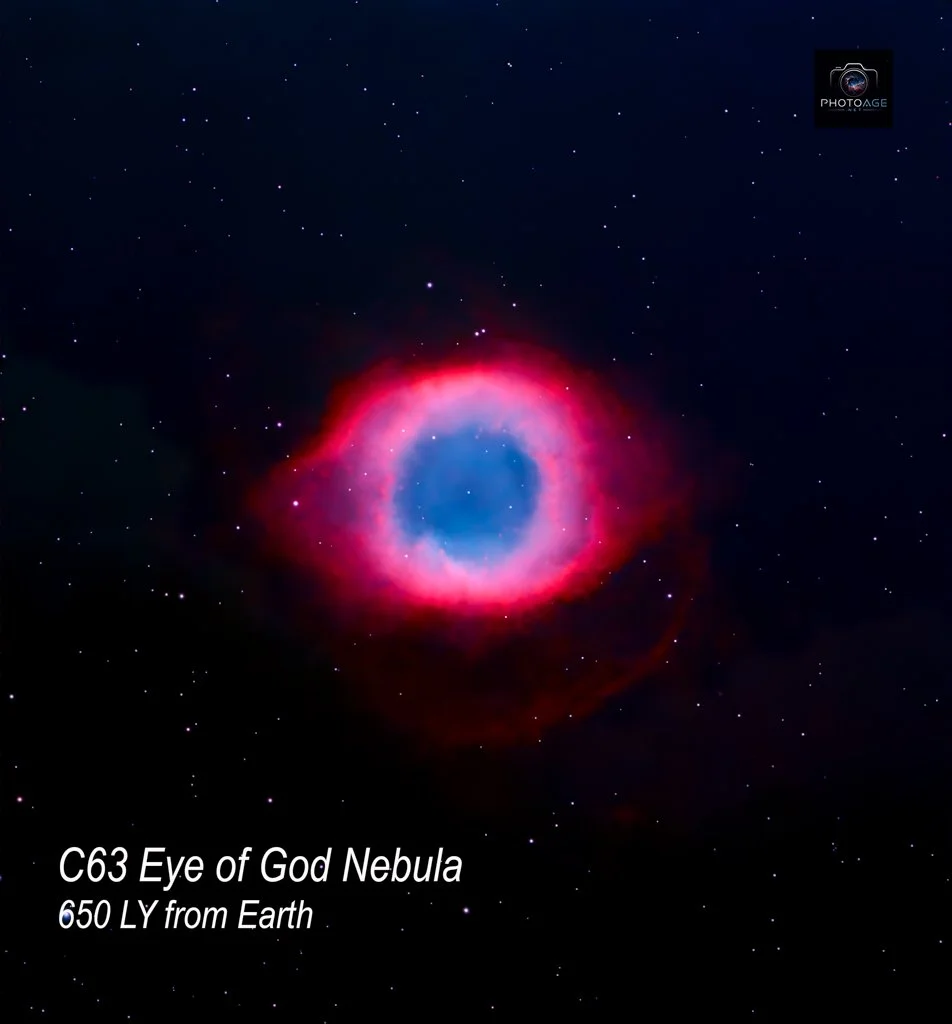 Image of the C63 Eye of God Nebula, a colorful astronomical nebula with red, pink, and blue hues, set against a star-filled black sky. Text indicates it is 650 light-years from Earth.