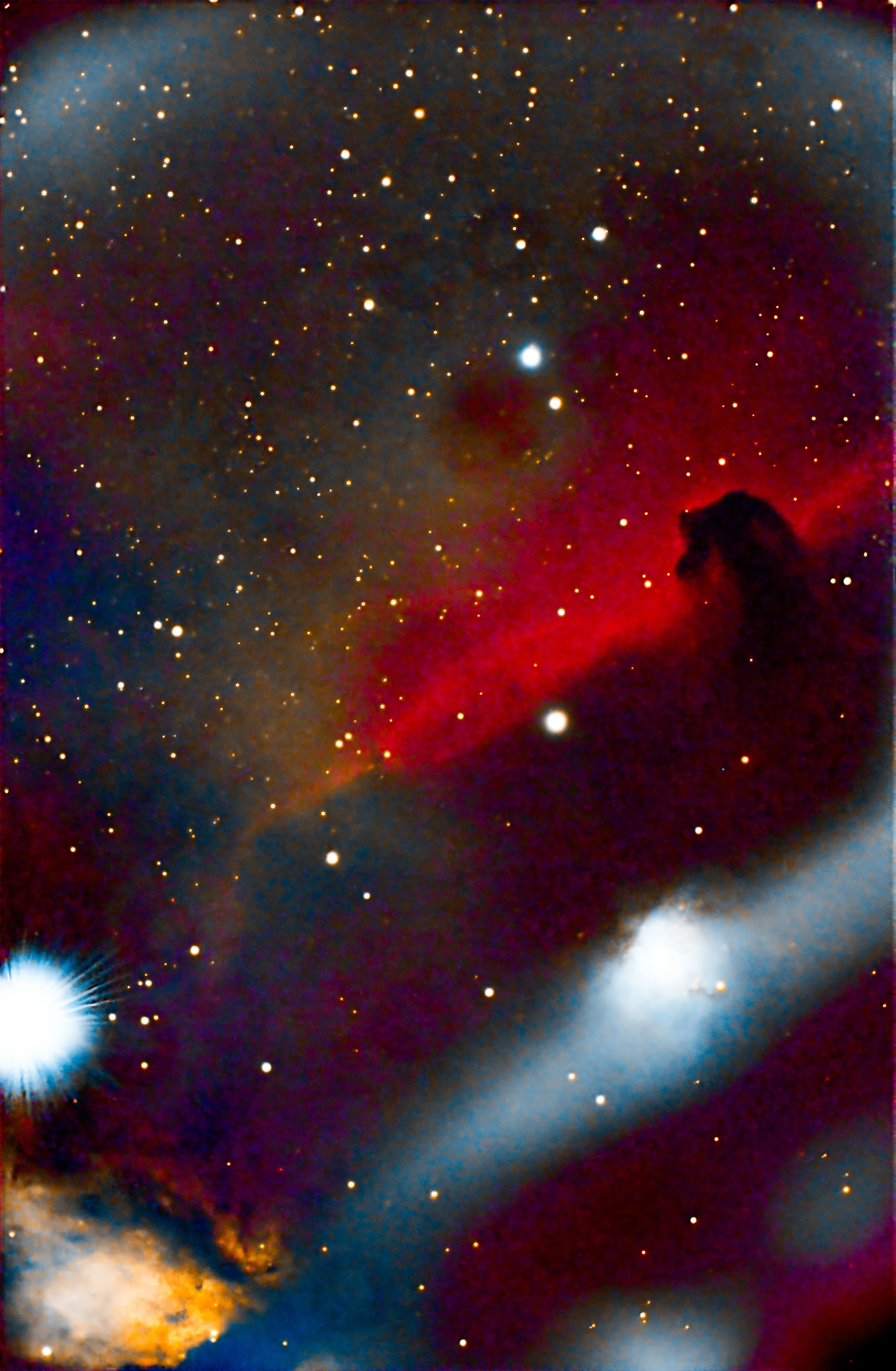 Deep space image showing countless stars, colorful nebulae, and cosmic clouds in shades of red, blue, and orange.