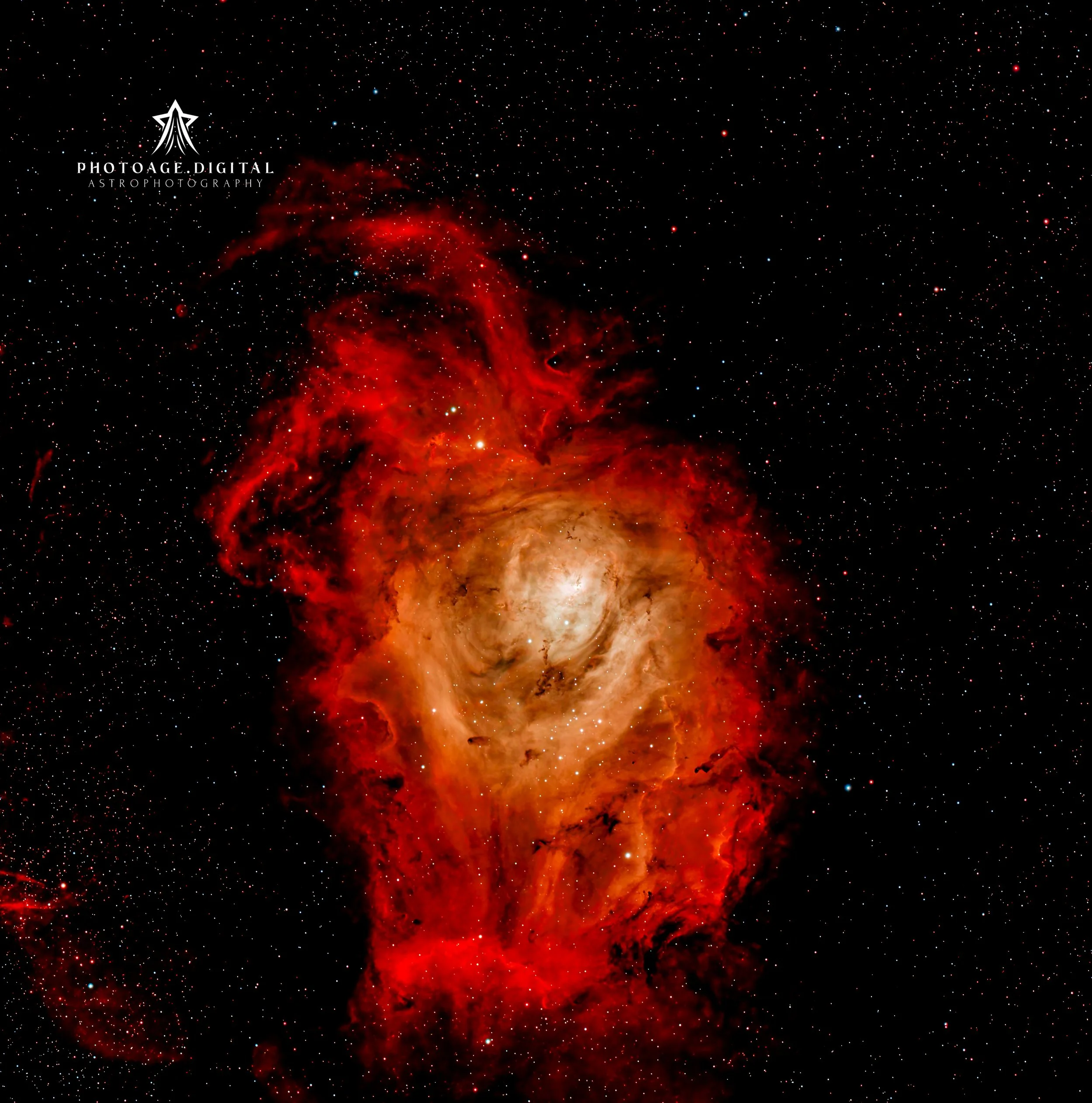A vivid image of a nebula with bright red and orange clouds of gas and stars against a dark background filled with numerous tiny white and blue stars.
