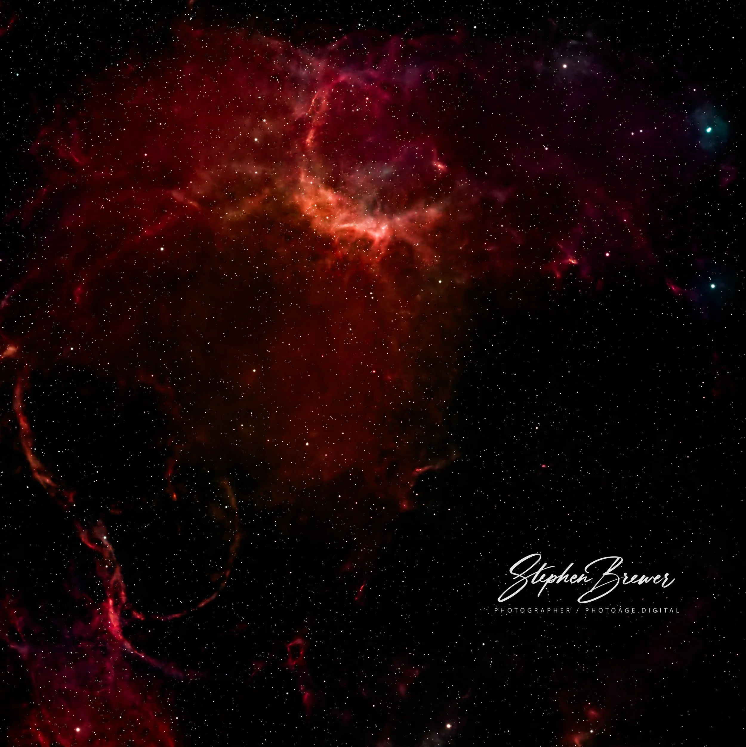 A view of outer space with numerous small stars and bright nebulae, predominantly red and dark tones.