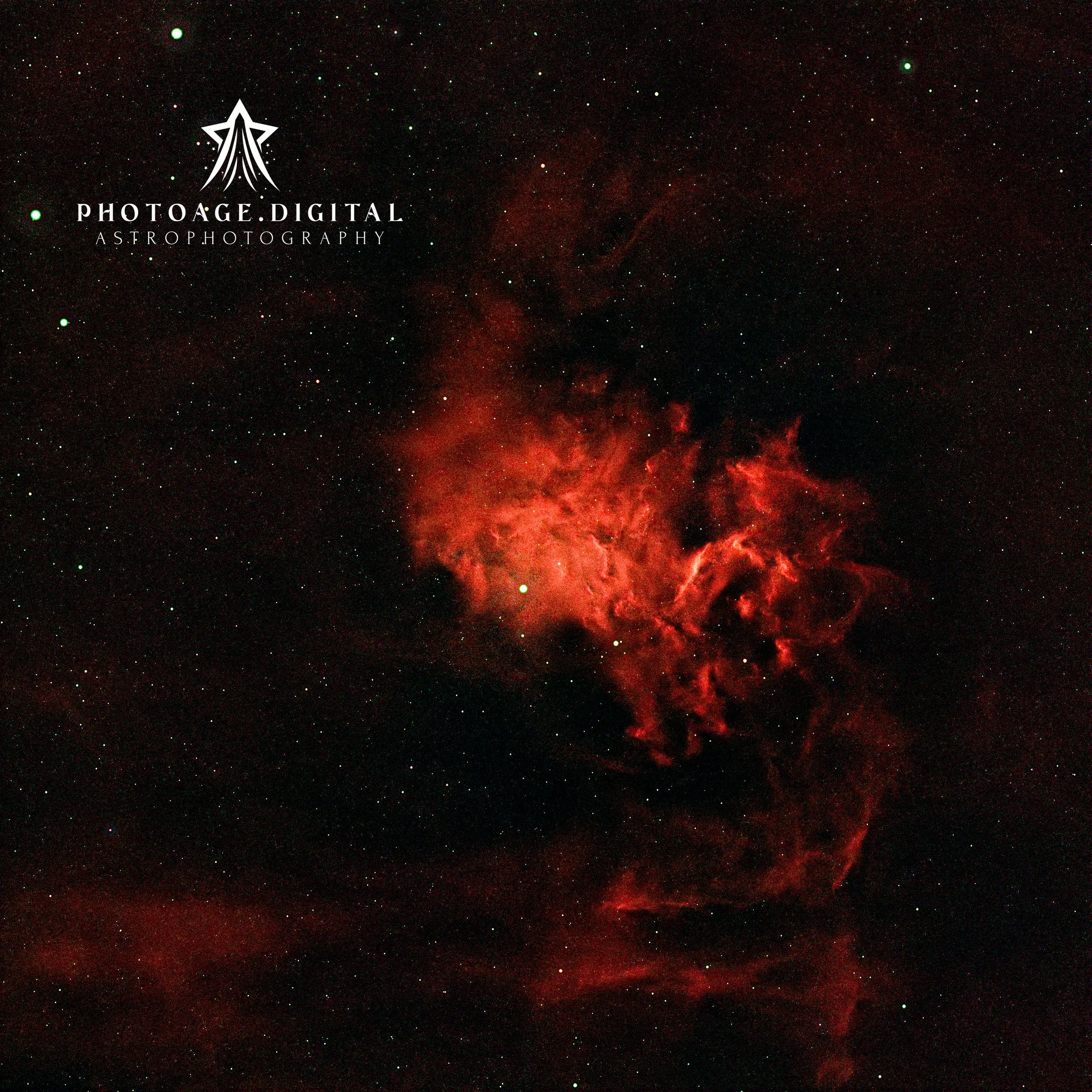 A starry night sky with numerous stars and red nebula clouds, featuring a logo for PhotoAge Digital Astro Photography in the lower left corner.