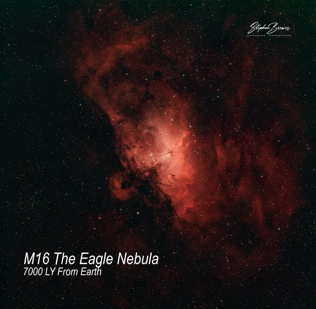 A photograph of the Eagle Nebula, a red and orange glowing cloud of gas and dust in space, with many stars scattered across the background. The text on the image reads "M16 The Eagle Nebula, 7000 LY From Earth".
