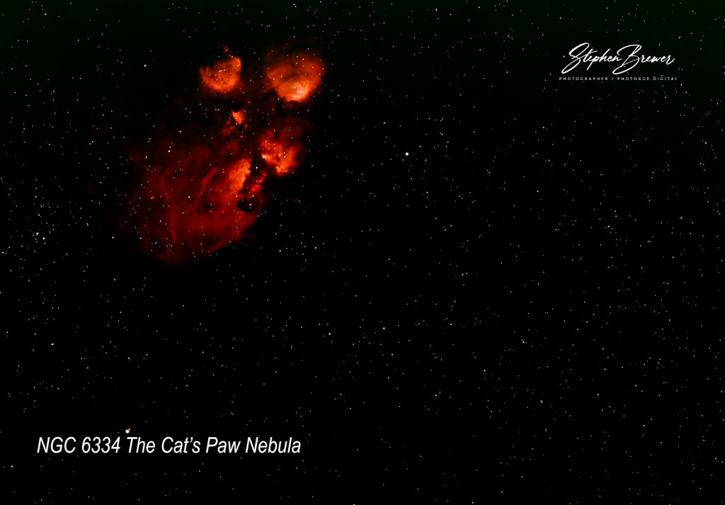 A deep space photograph of NGC 6334, known as The Cat's Paw Nebula, showing a bright red, cloud-like nebula with twinkling stars in the background.