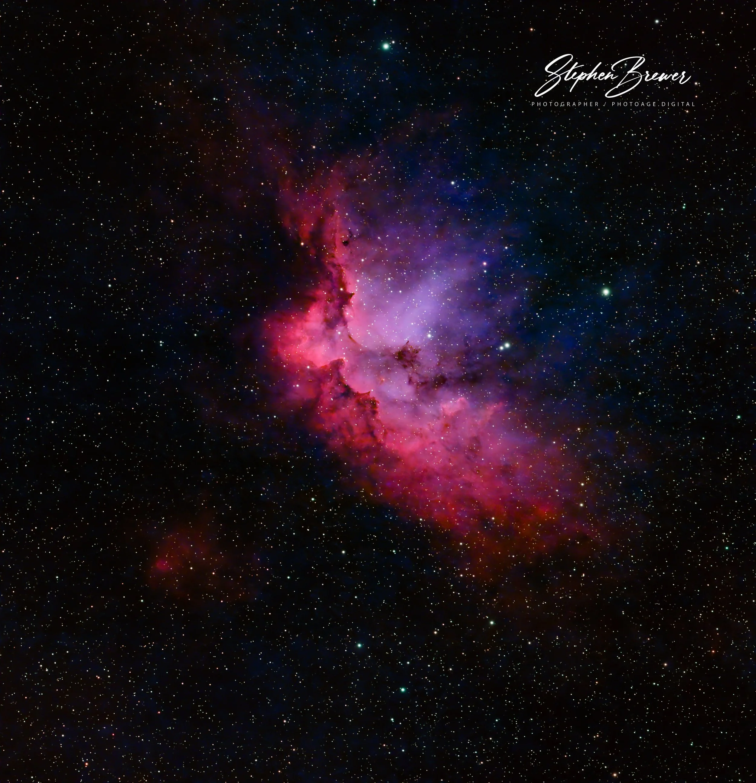 A vibrant view of space showing numerous stars and cosmic dust, with a bright nebula and colorful gas clouds in red, purple, and pink hues.