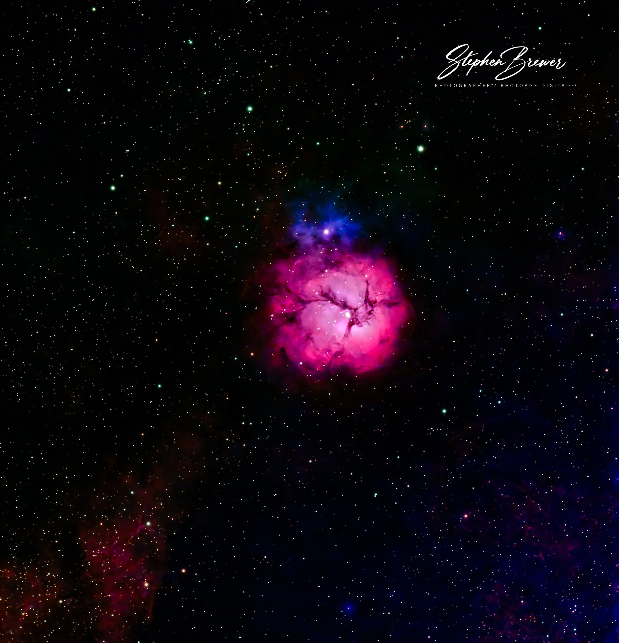 Deep space image showing a colorful nebula with bright star formations and numerous stars scattered across the black background.