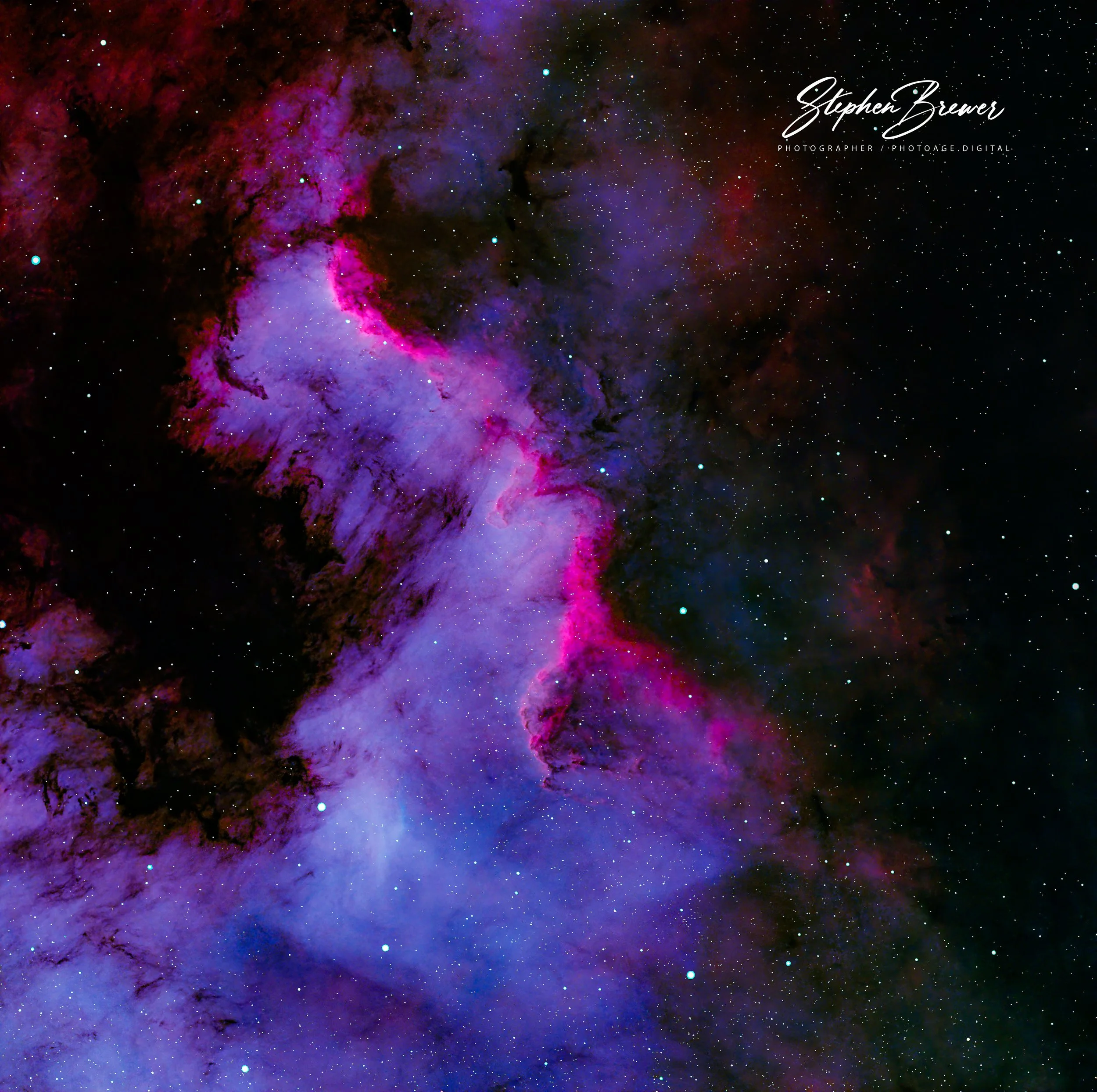 Colorful image of a nebula in space with pink, purple, and black hues, scattered with stars.