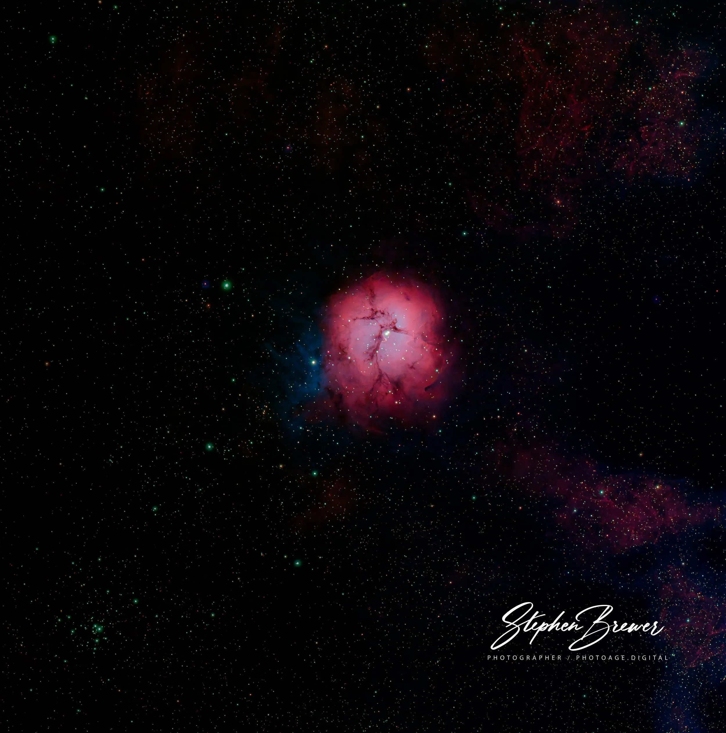 A vibrant image of space featuring numerous stars and a glowing pink nebula in the lower right corner. The image includes a signature of Stephen Brewer and the text 'PHOTOGRAPHER / PHOTOAGE.DIGITAL' at the bottom right.