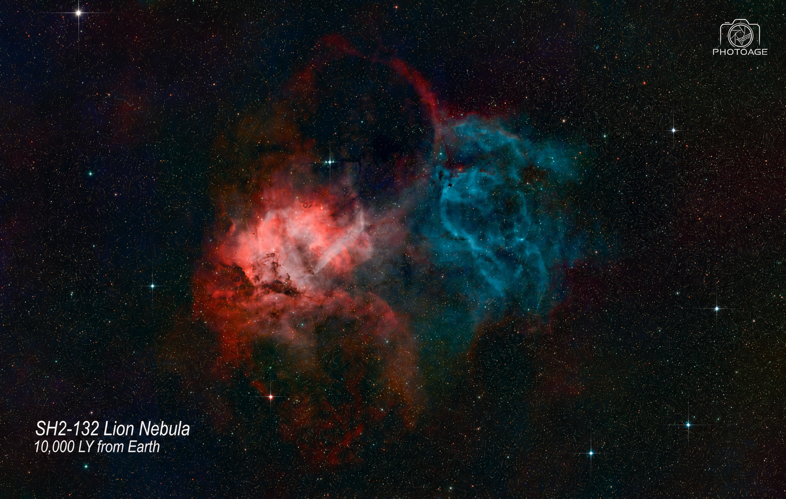 Image of the SH2-132 Lion Nebula, a colorful nebula with red and blue clouds, located 10,000 light years from Earth, with numerous stars in the background.