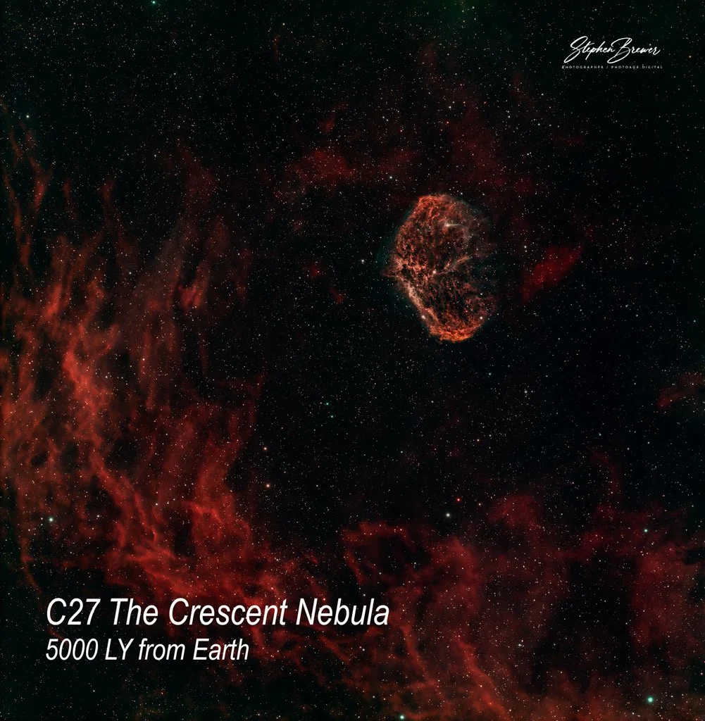 An image of the Crescent Nebula (NGC 6888) in space, with red and orange gaseous clouds, surrounded by stars. The text on the image reads 'C27 The Crescent Nebula, 5000 LY from Earth' and is credited to Stephen Brewer.
