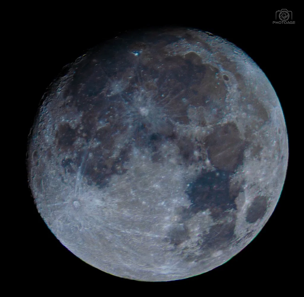 Close-up view of the moon showing its craters and surface details against a black background.