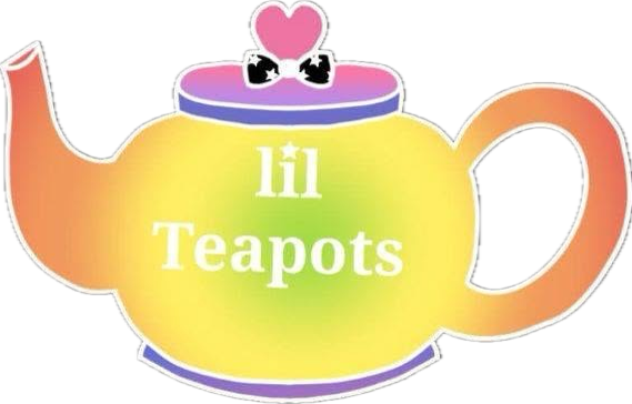 A teapot with a rainbow gradient, pink heart and black bow on lid, and text 'lil Teapots' on it.