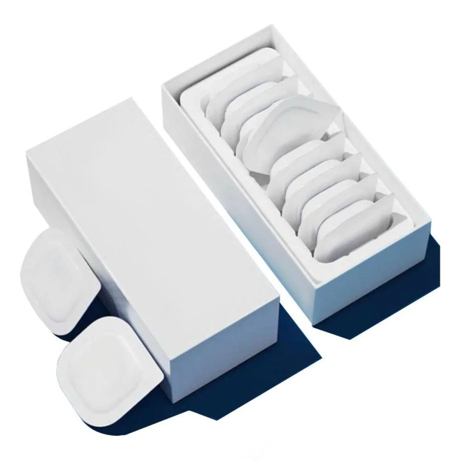A white box of individual packets containing medical ointments.