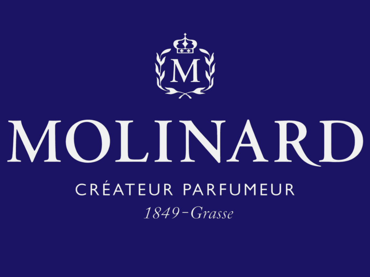 Logo de la marque Molinard avec une couronne et des lauriers, indiquant qu'elle est un créateur de parfums fondé en 1849 à Grasse.