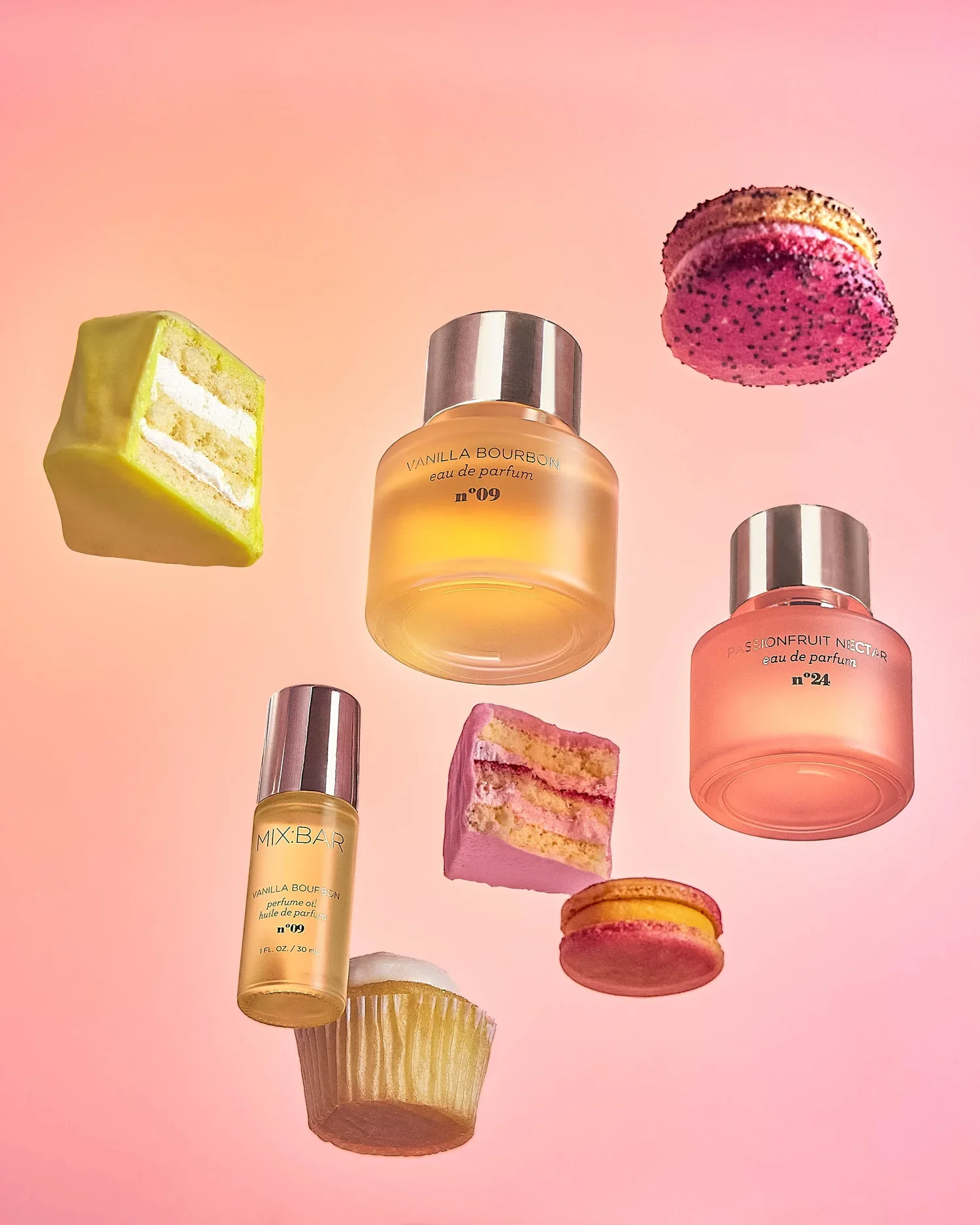 Various perfume bottles and slices of cake on a pink background.