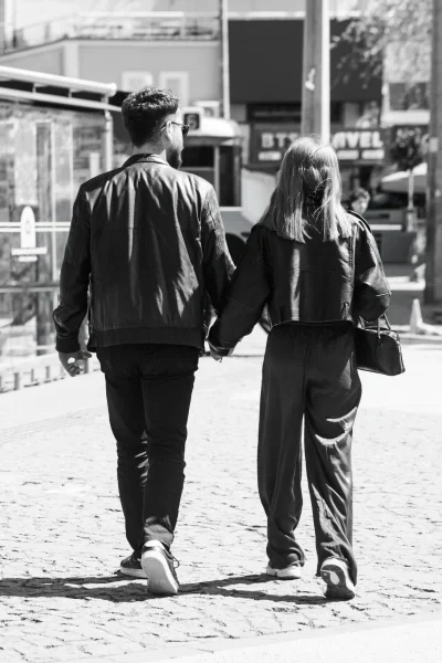 Young couple holding hands walking