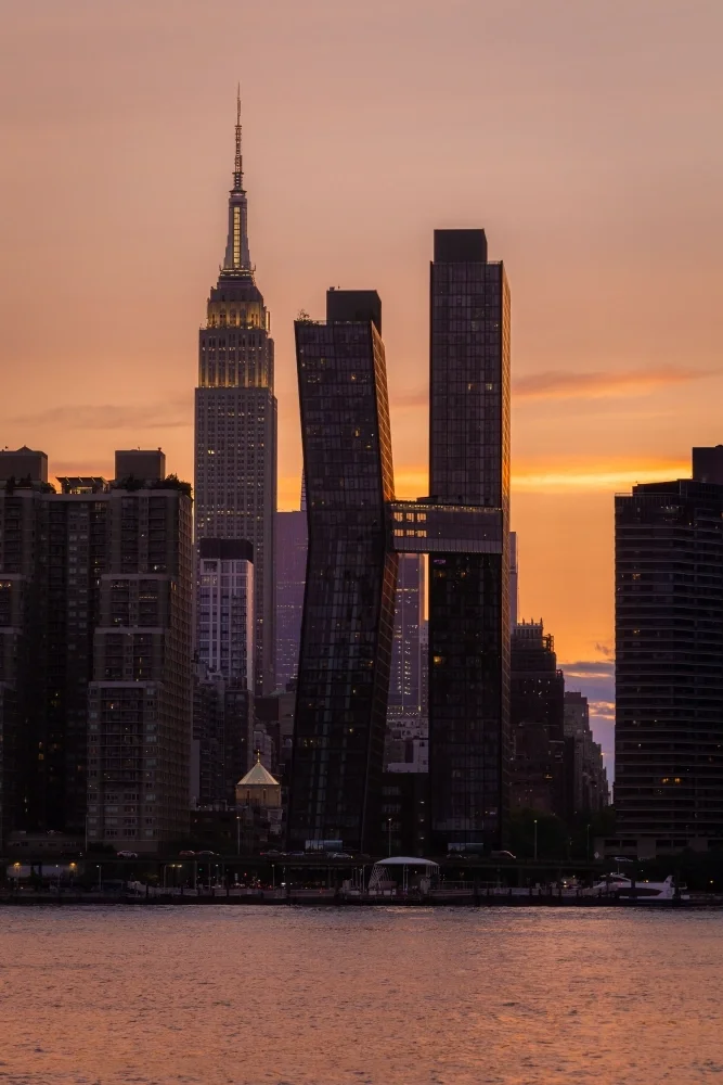 Side view of modern NYC buildings with Empire State Building in the background