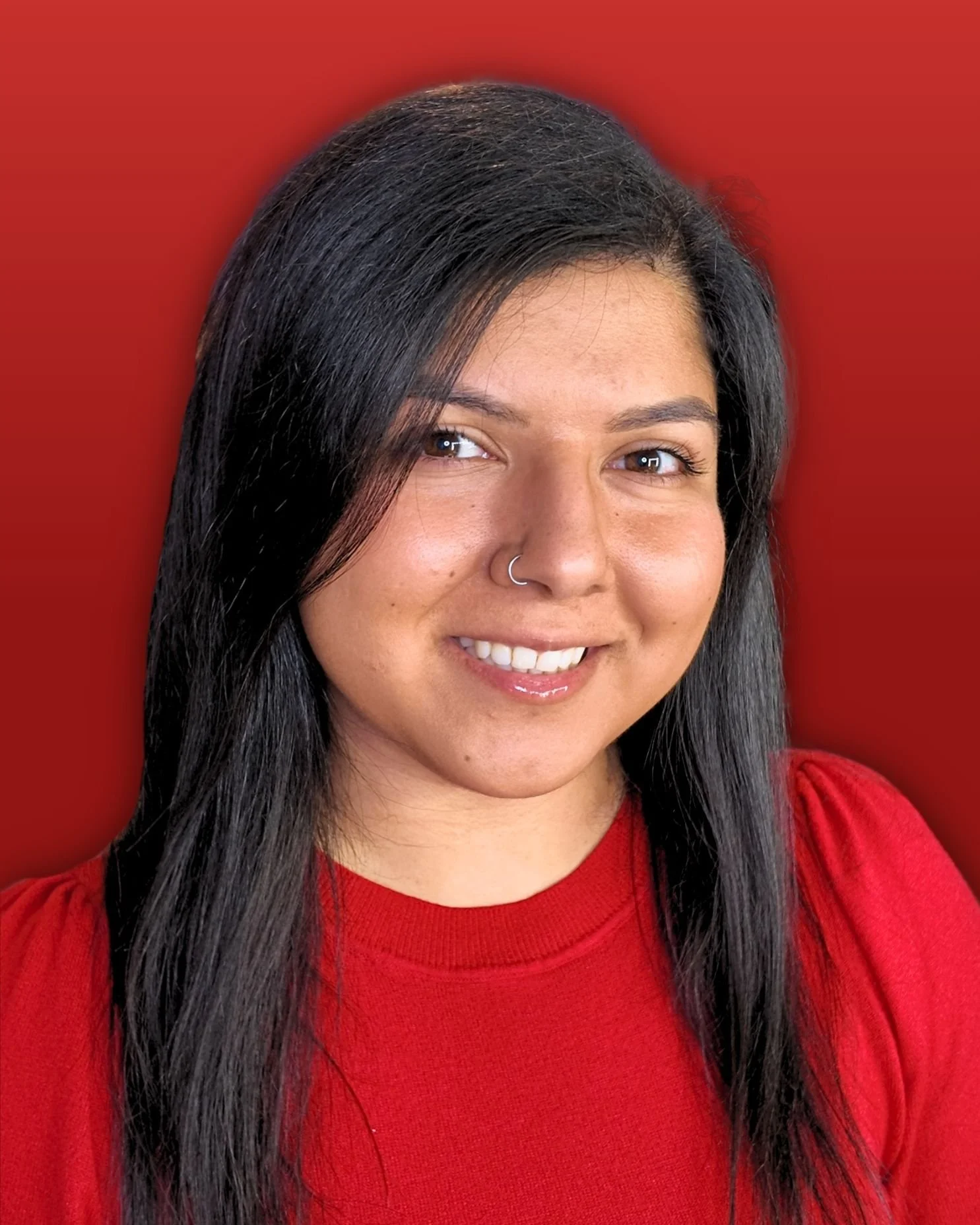 Selina, a woman in a red shirt smiling at the camera.