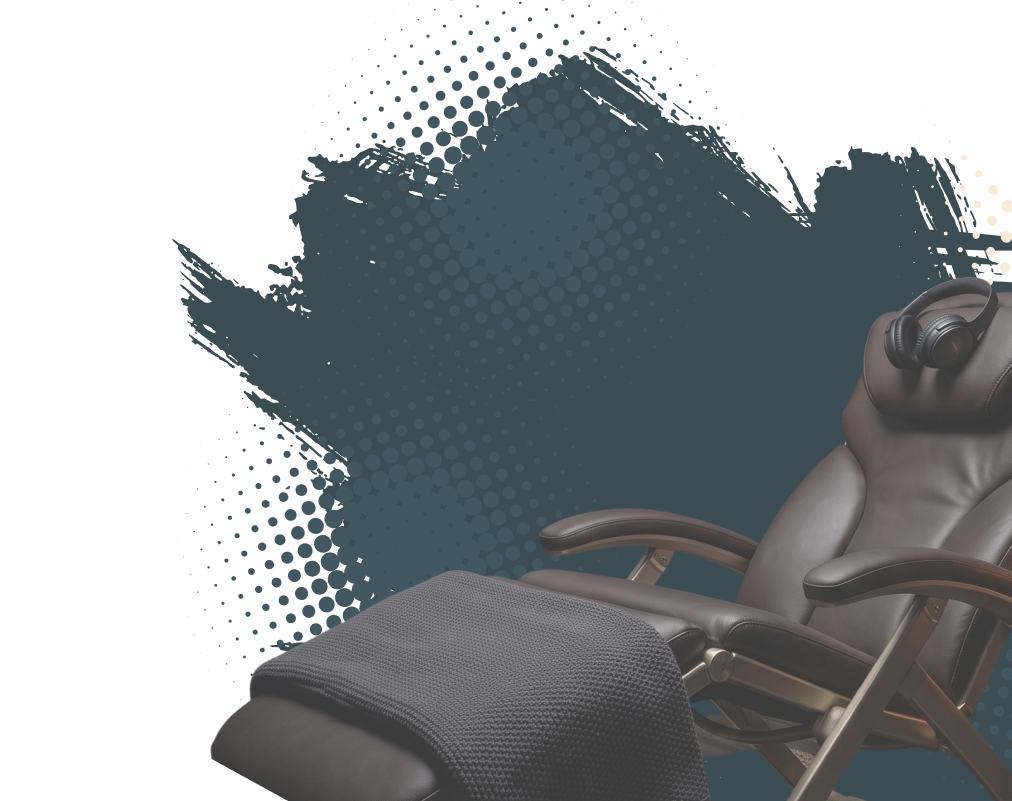 Relaxing office chair with headphones on the headrest and a blanket draped over the footrest, set against a dark abstract background.