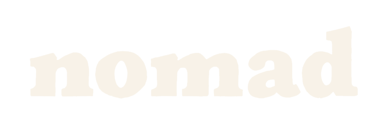 The word 'nomad' written in large, bold, white font against a black background.