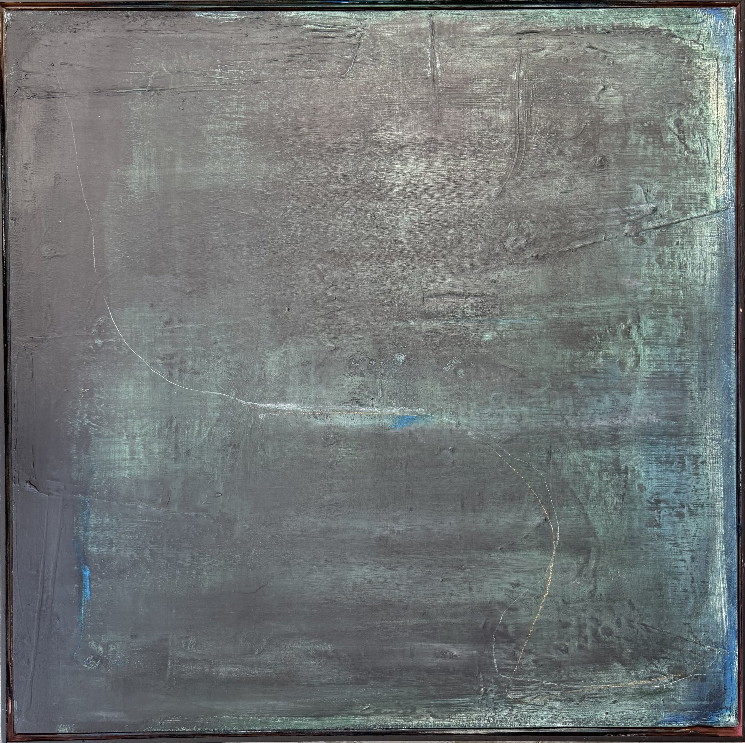 A large rectangular abstract painting with a textured surface in shades of gray, with hints of blue and green, framed in a thin dark brown border.