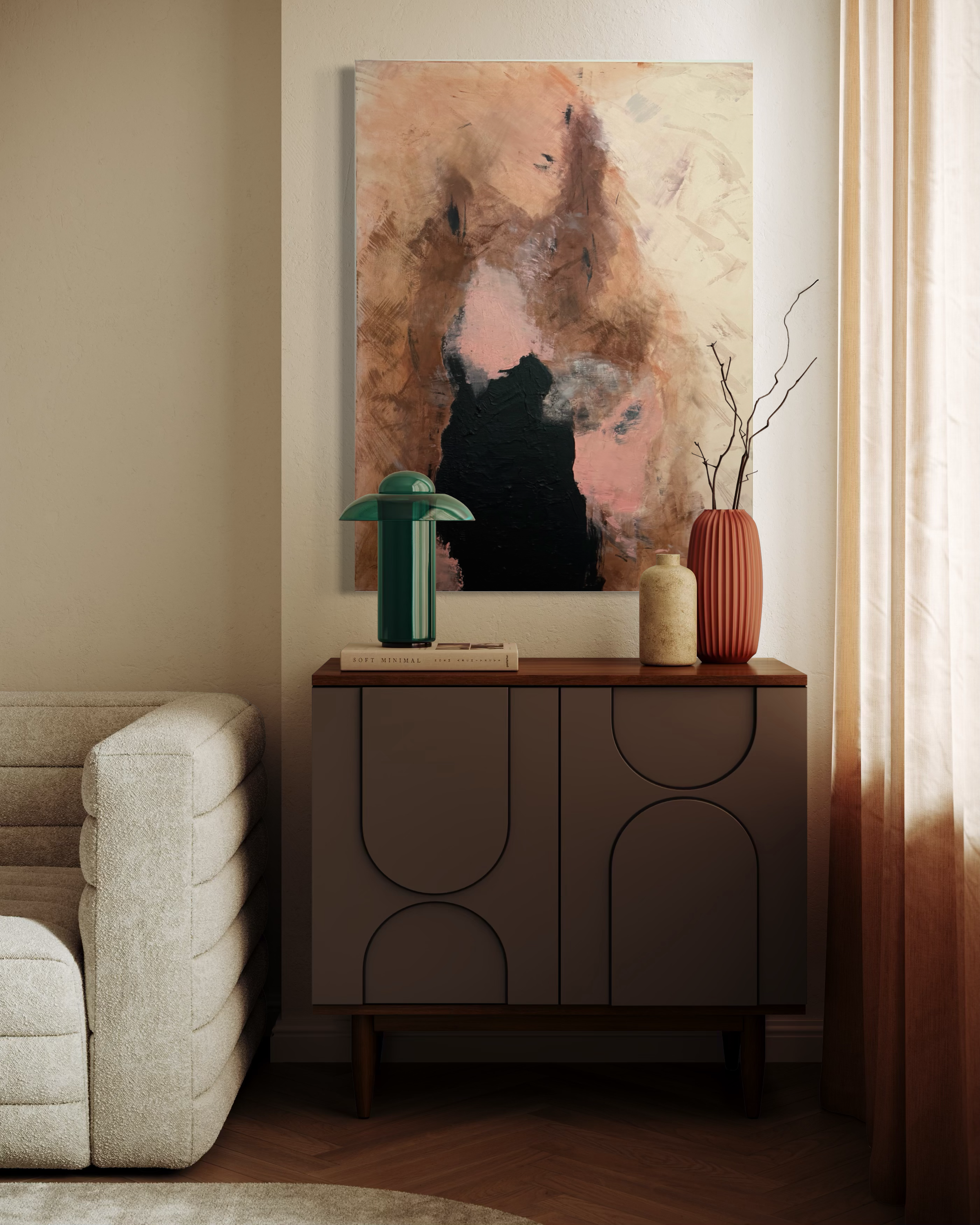 A living room corner with a beige sofa, a dark wood cabinet, and abstract art on the wall, with decorative vases and a curtain.