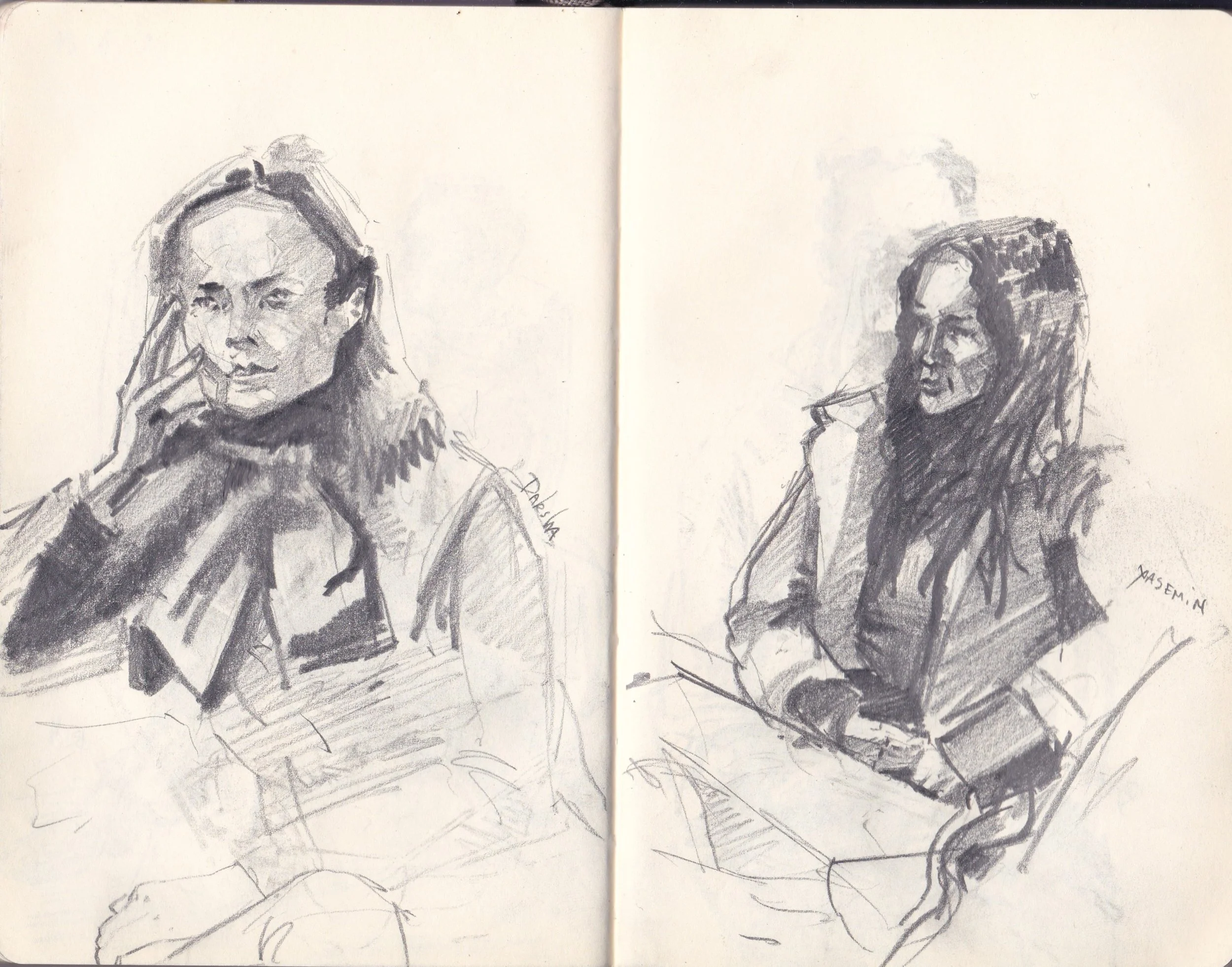 A black and white sketch of two women, one on each side of a spread in a notebook. The woman on the left has a thoughtful expression, with her hand near her face. The woman on the right appears to be smoking, with glasses and long hair.