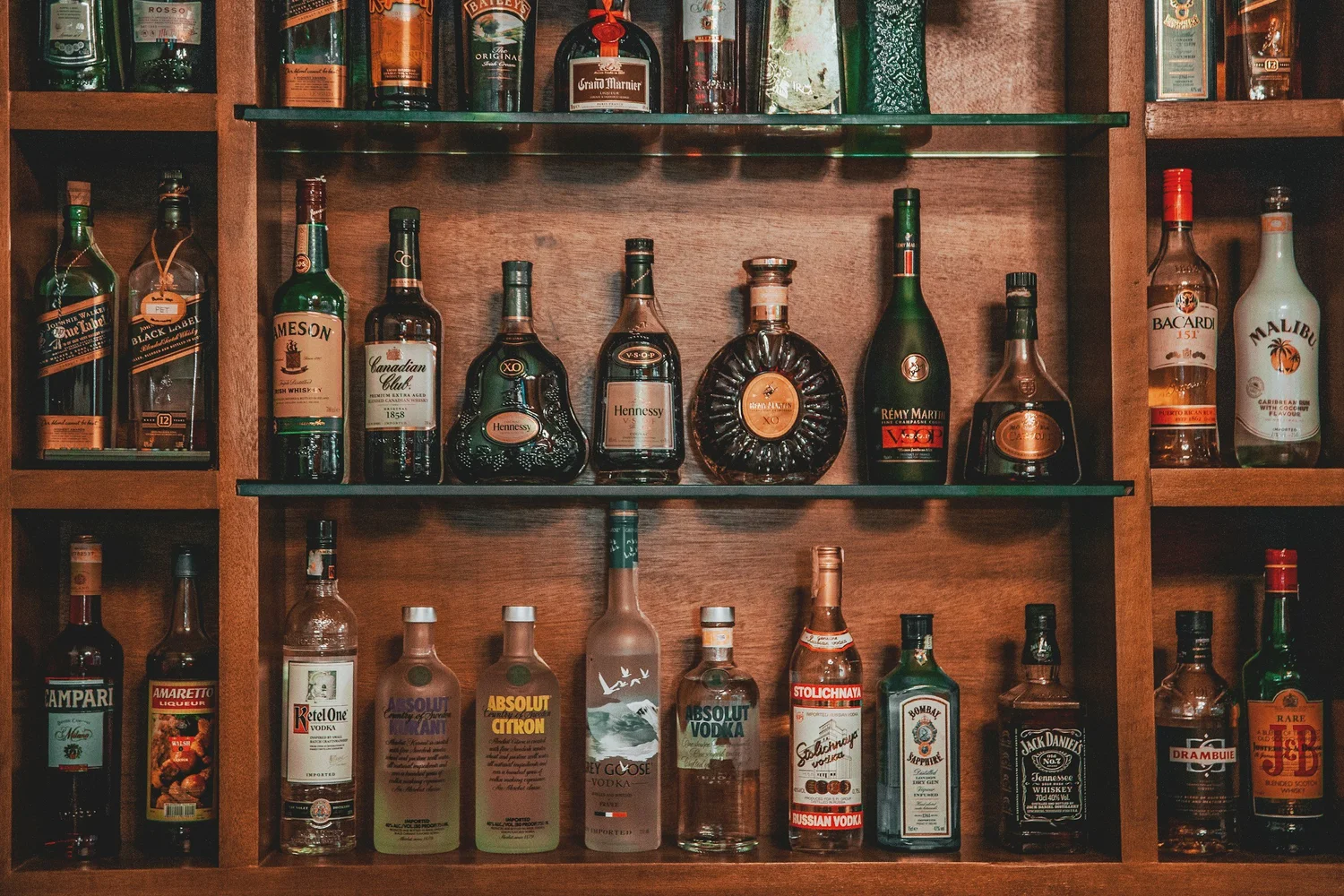 Liquor store shelves stocked with bottles. Tobacco License