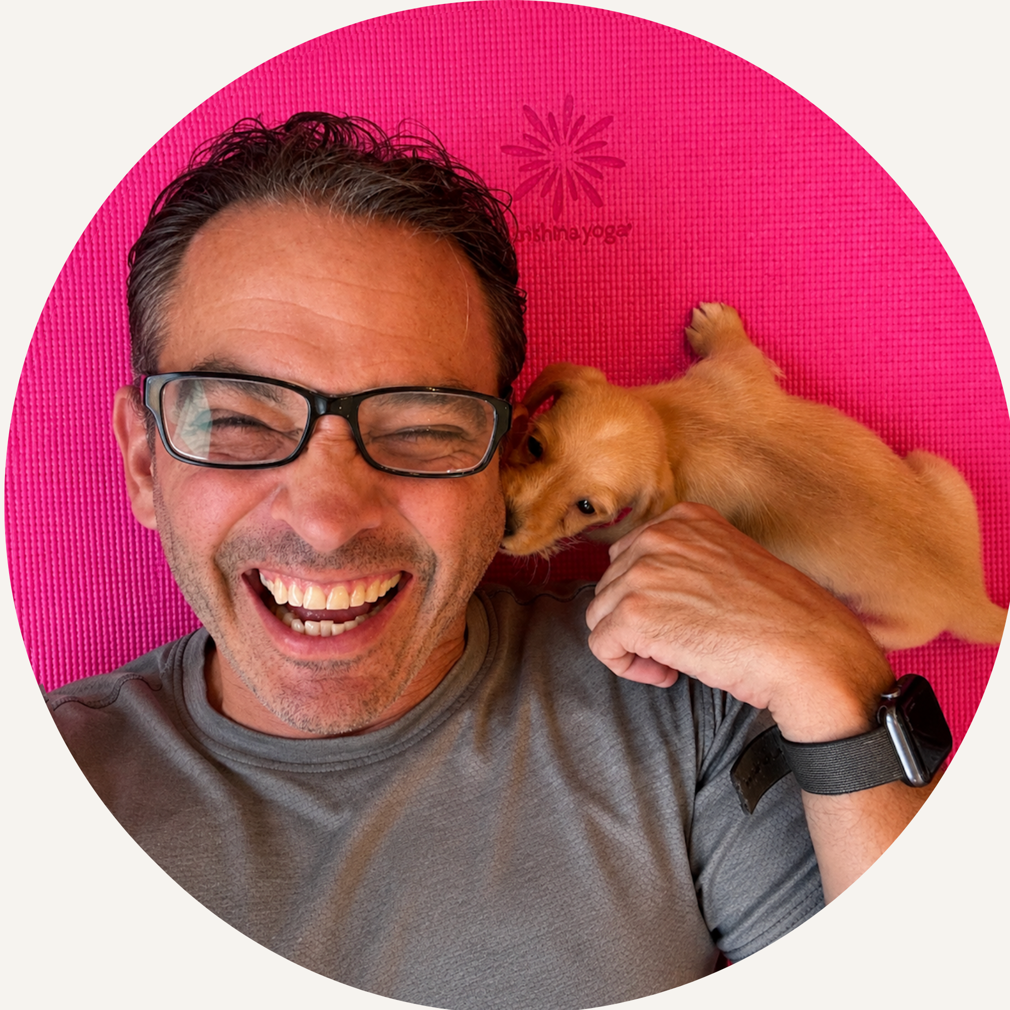 Picture of Marc Engel laughing during puppy yoga.