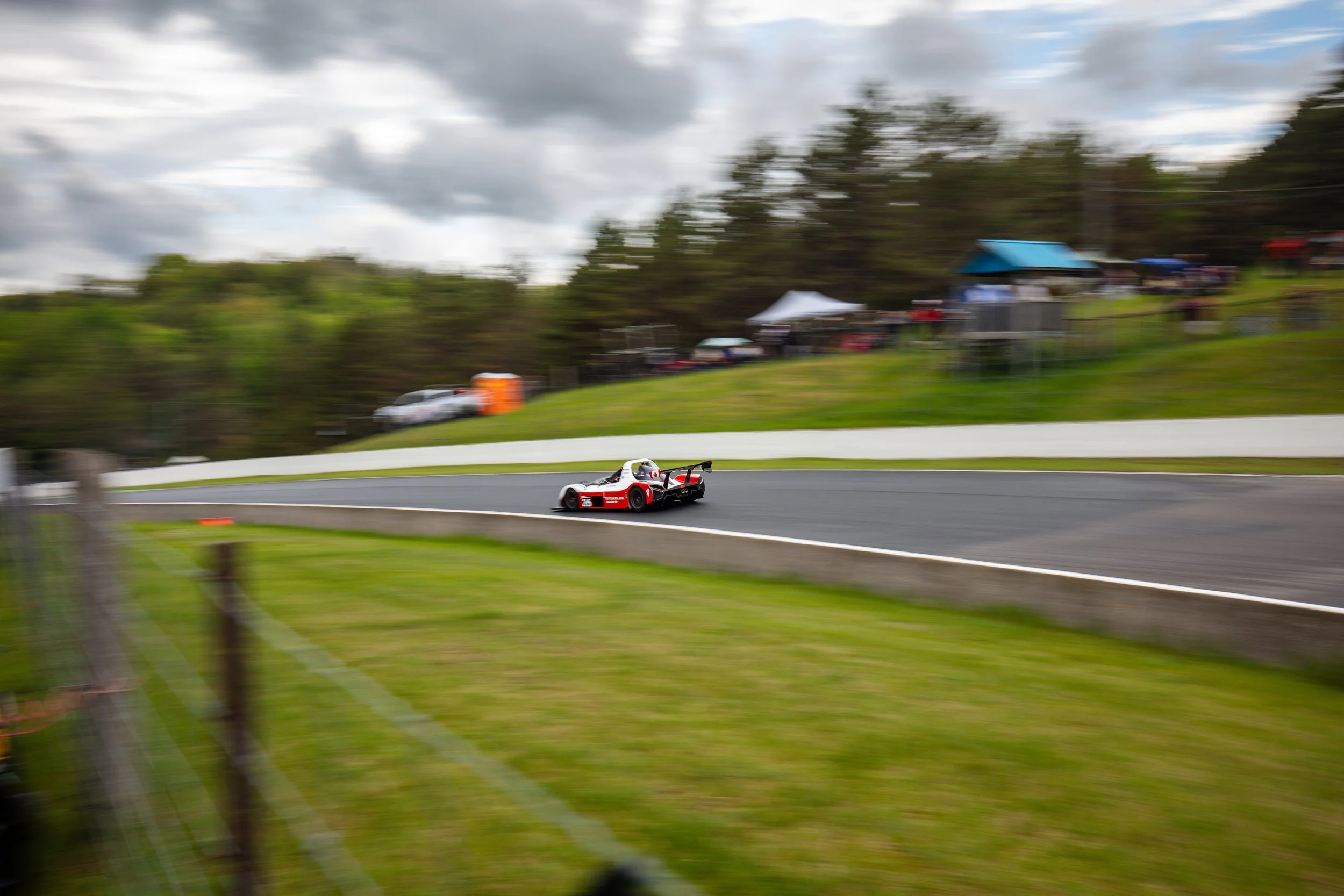 A race car driving on a racetrack with motion blur background.
