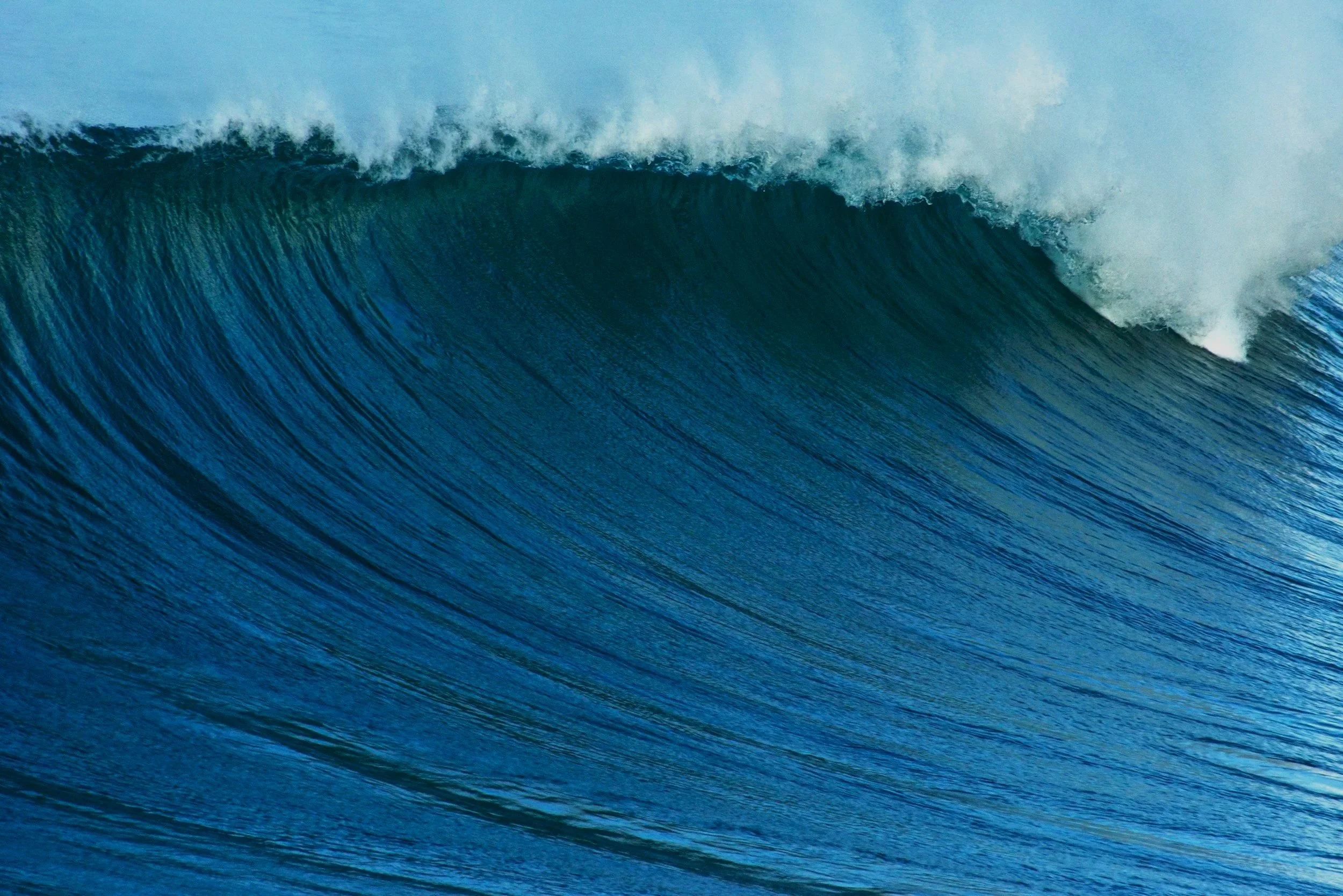 A large ocean wave about to break in the ocean.