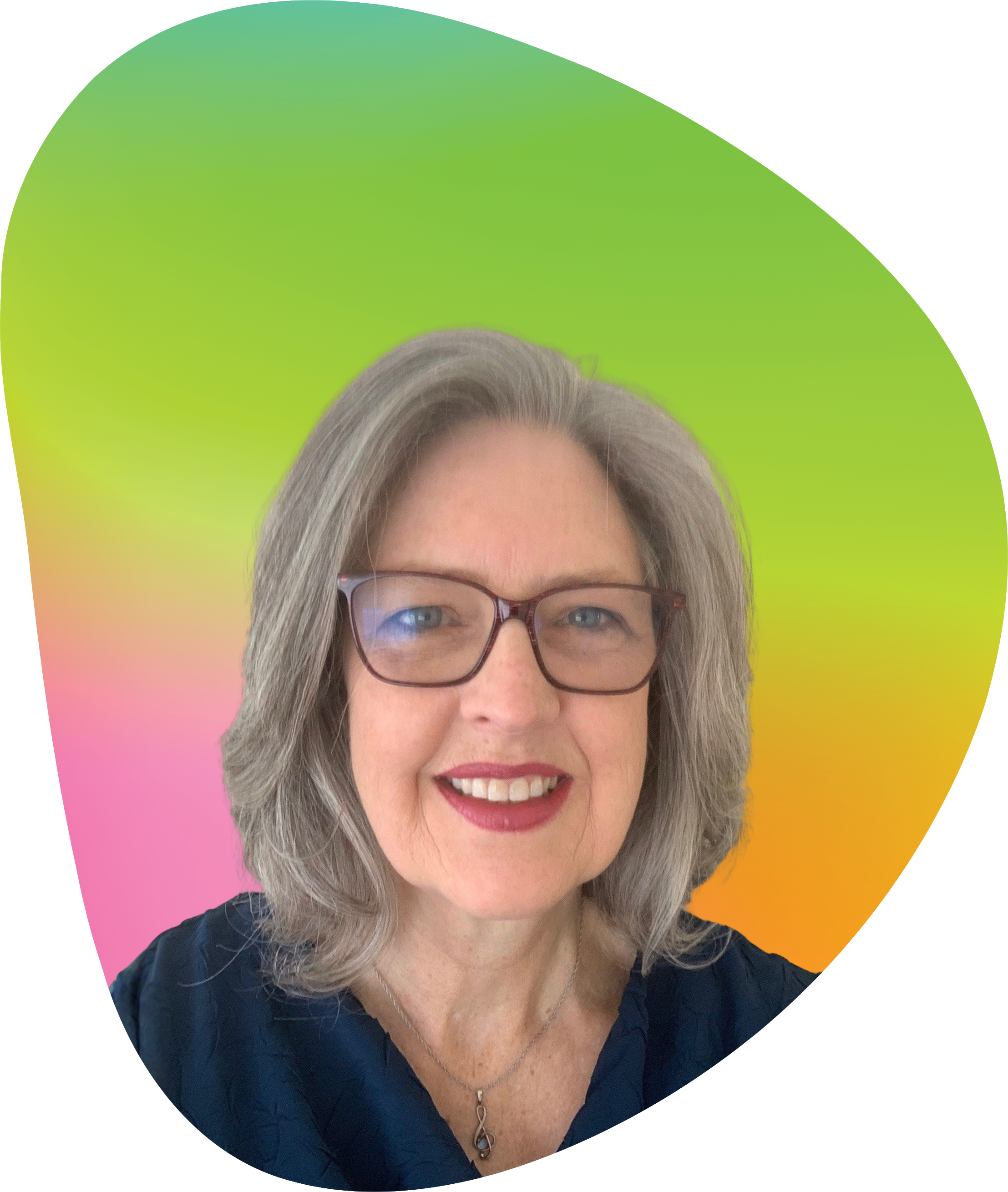 A woman with gray hair and glasses smiling in front of a green, yellow, and pink gradient background.