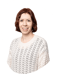A woman with short brown hair wearing a white knitted sweater, smiling, against a white background with a black circular border.