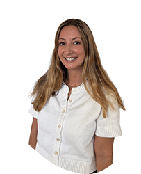 A woman with long blonde hair smiling, wearing a white short-sleeved shirt, against a white background.