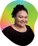 Portrait of a smiling woman with curly hair, wearing a dark top, against a colorful gradient background.