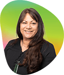 Portrait of a woman with long dark hair, smiling, against a vibrant green and pink gradient background.