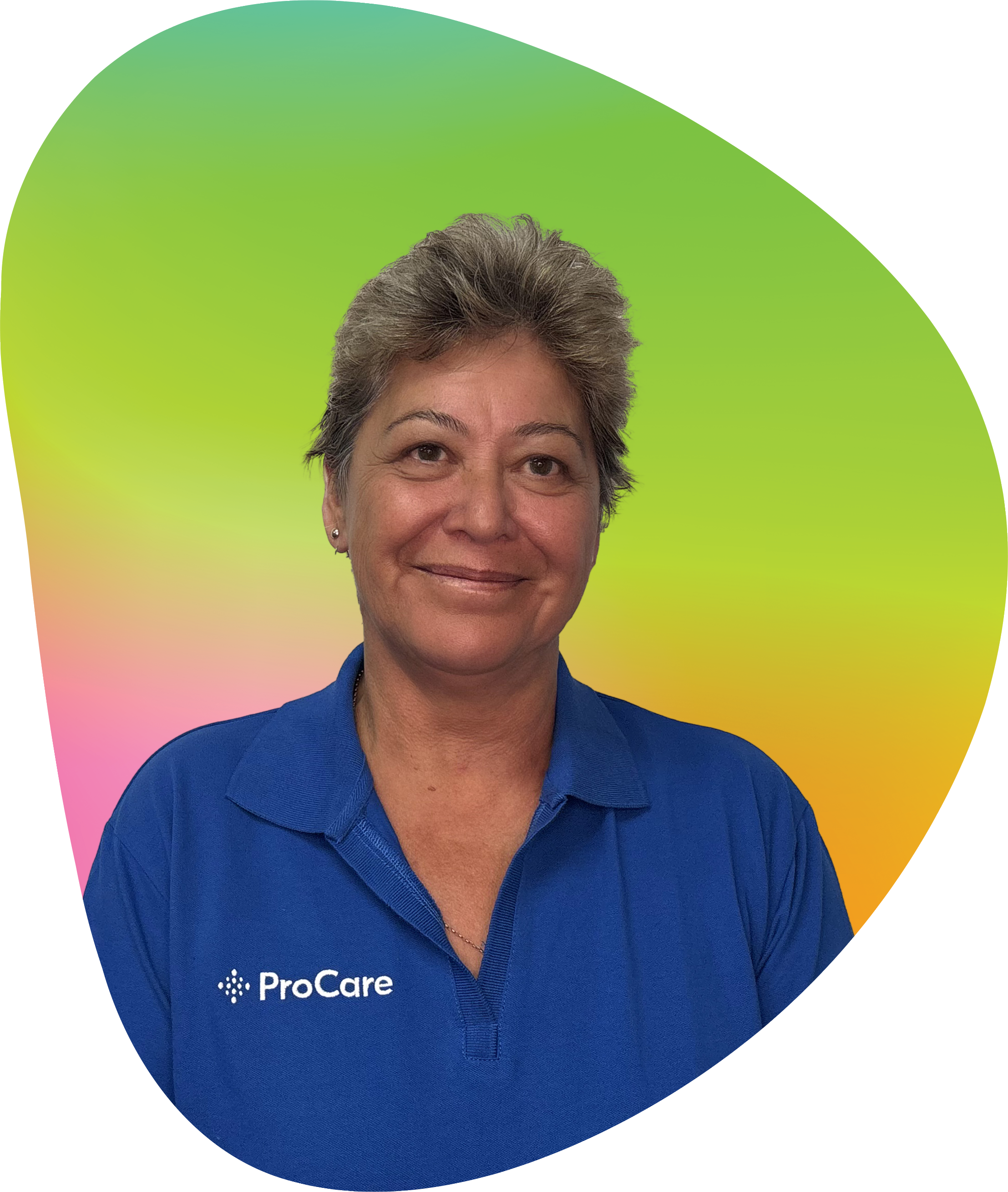 A woman with short, gray hair wearing a blue ProCare polo shirt, smiling, against a colorful gradient background.