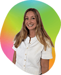A smiling woman with long hair wearing a white shirt, standing in front of a colorful circular background with green, pink, and yellow sections.