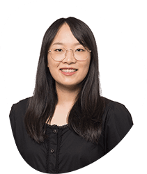 A woman with long black hair, glasses, and a black outfit, smiling against a white background.