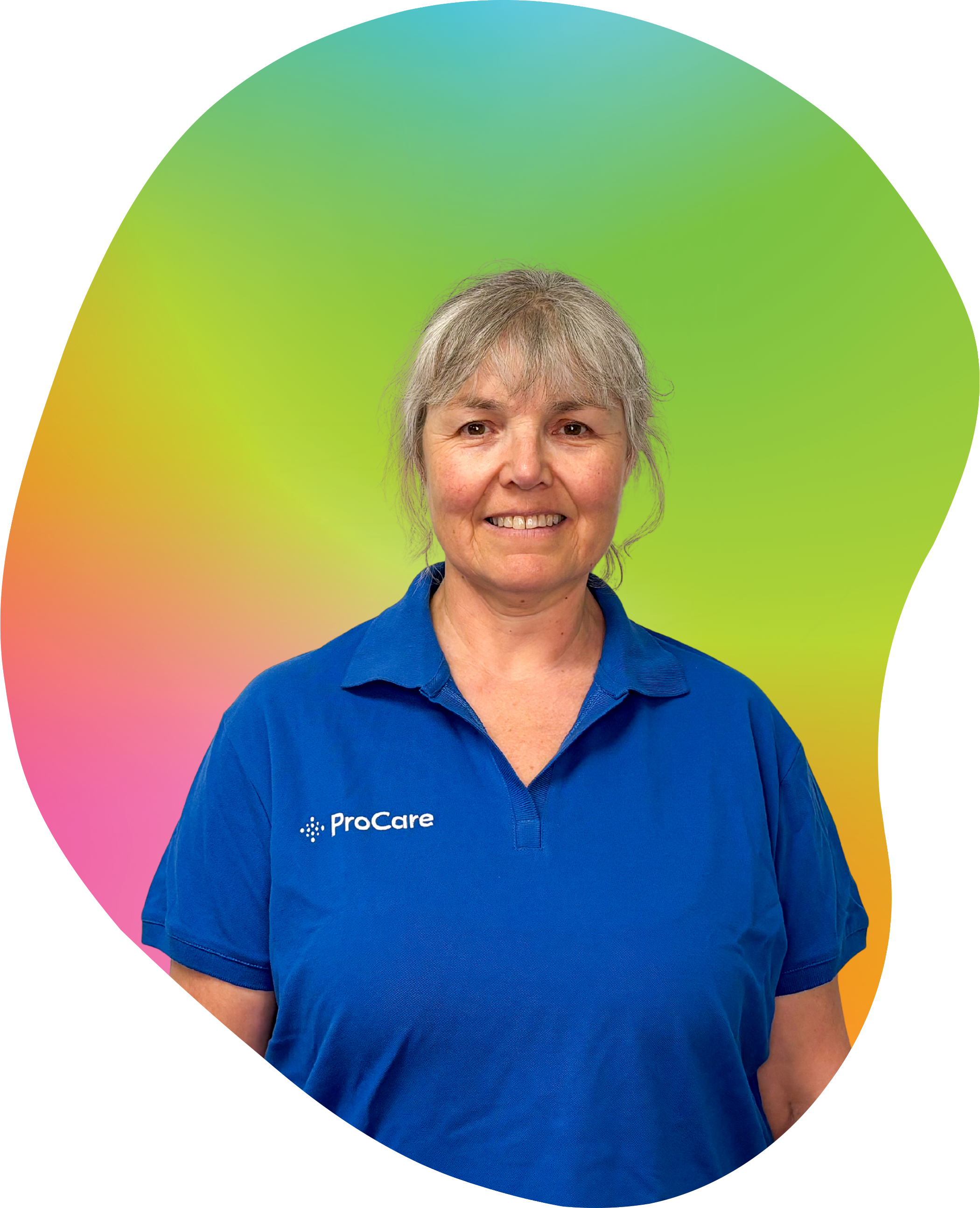 A woman with gray hair, smiling, wearing a blue polo shirt with 'ProCare' logo, on colorful gradient background.