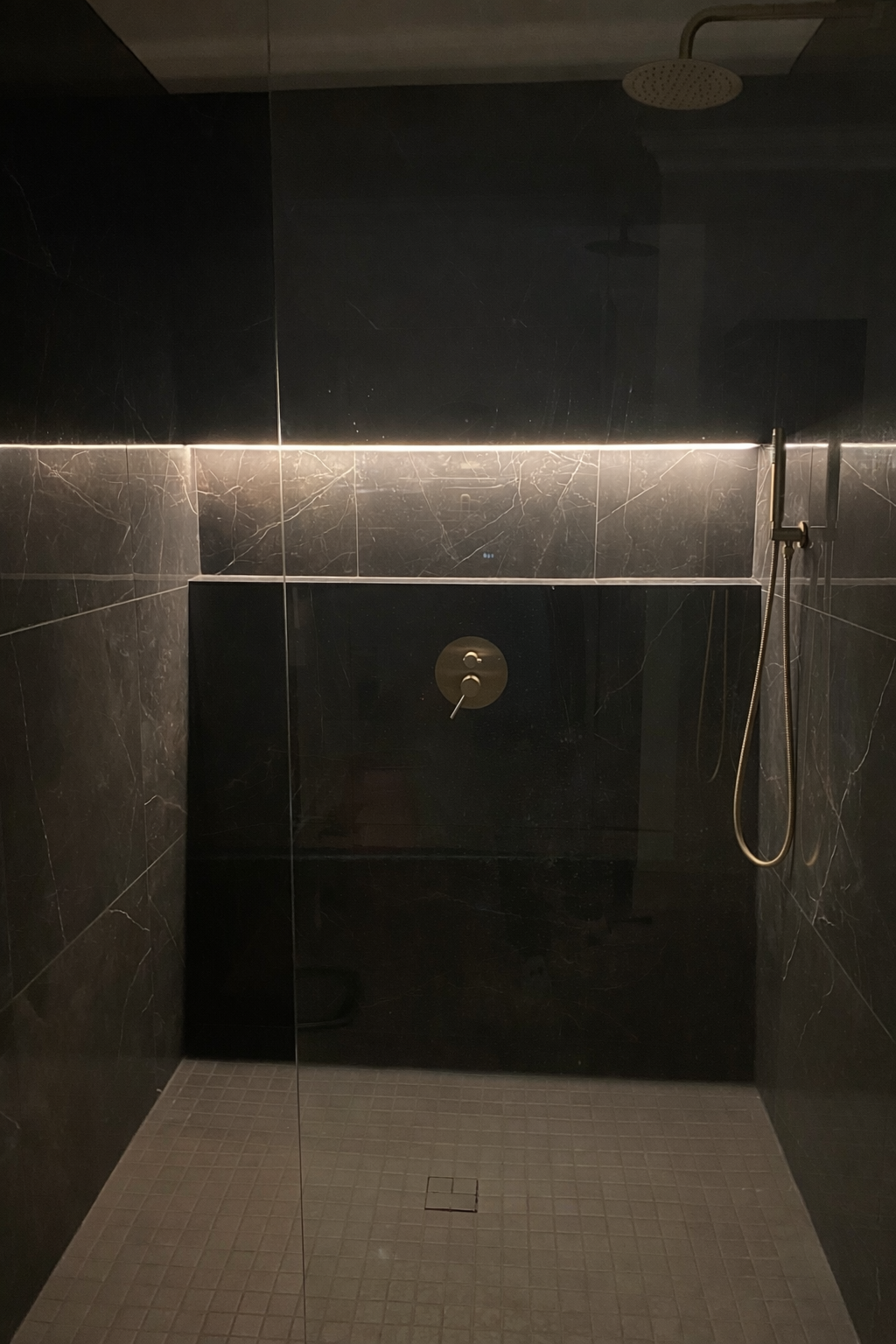 Contemporary bathroom with brass accents.png
