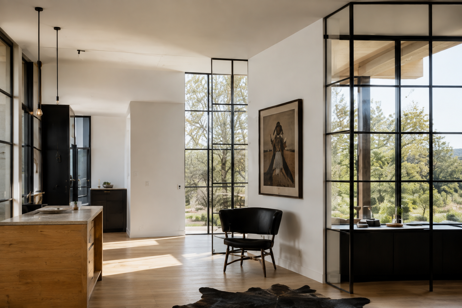 Minimal interior with black steel windows, pale wood floors, framed artwork, and a black chair.