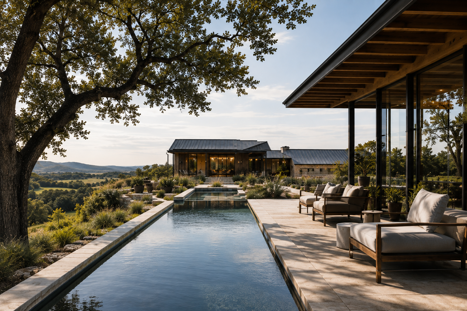 Long swimming pool extending toward a distant Hill Country view beside a covered outdoor living area.