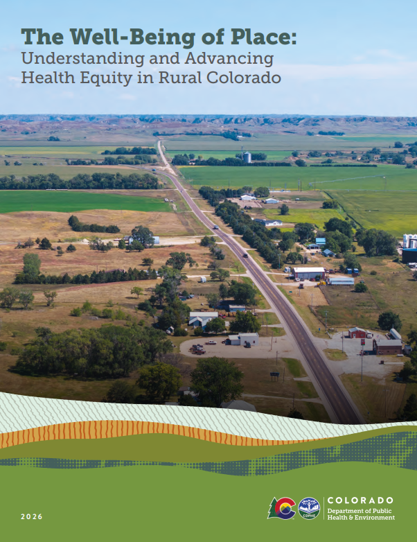 A rural Colorado landscape with open fields, scattered trees, a few buildings, and a road running through the area, seen from an aerial view.